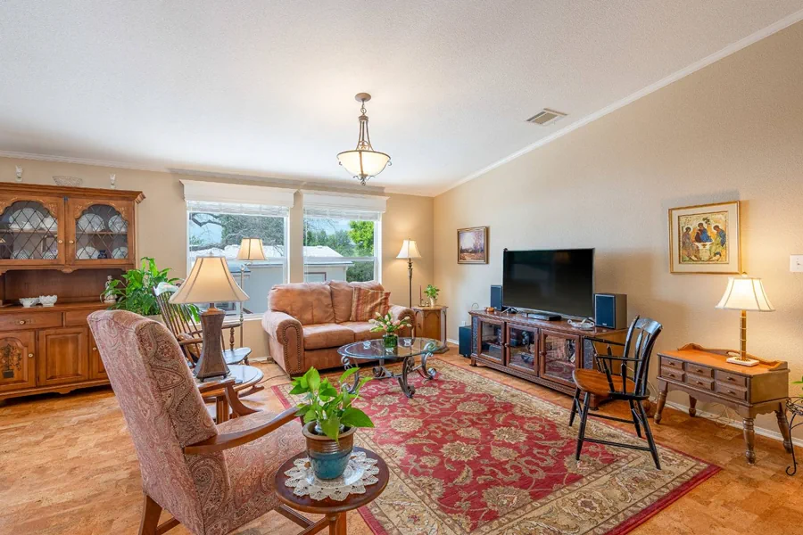 Bright and spacious living room with comfortable seating and large windows overlooking green hill country landscape creating a welcoming and peaceful atmosphere